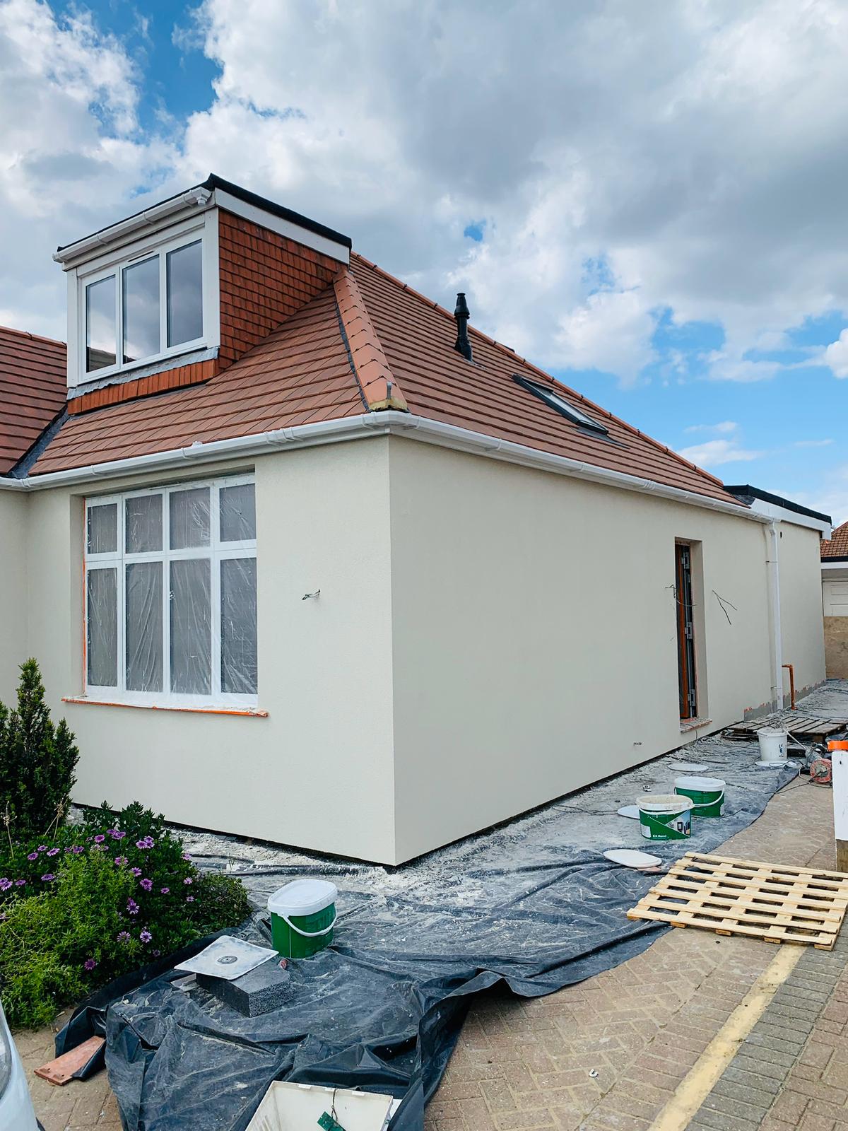 A dormer roof and newly rendered walls, photographed during finishing work.