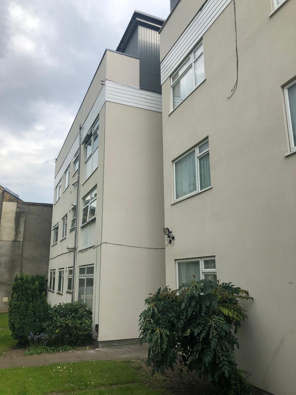 A consistent light finish across the exterior of a residential block.