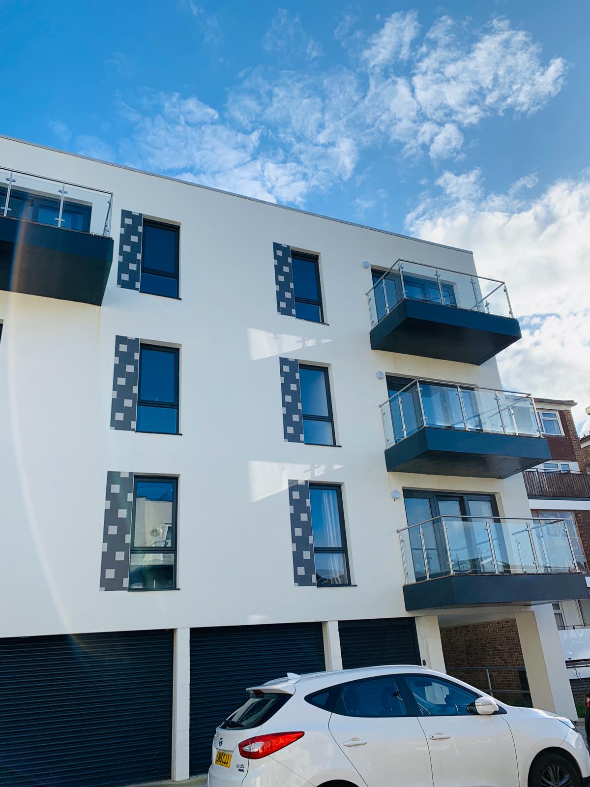 Light render and contrasting window details define this contemporary apartment exterior.