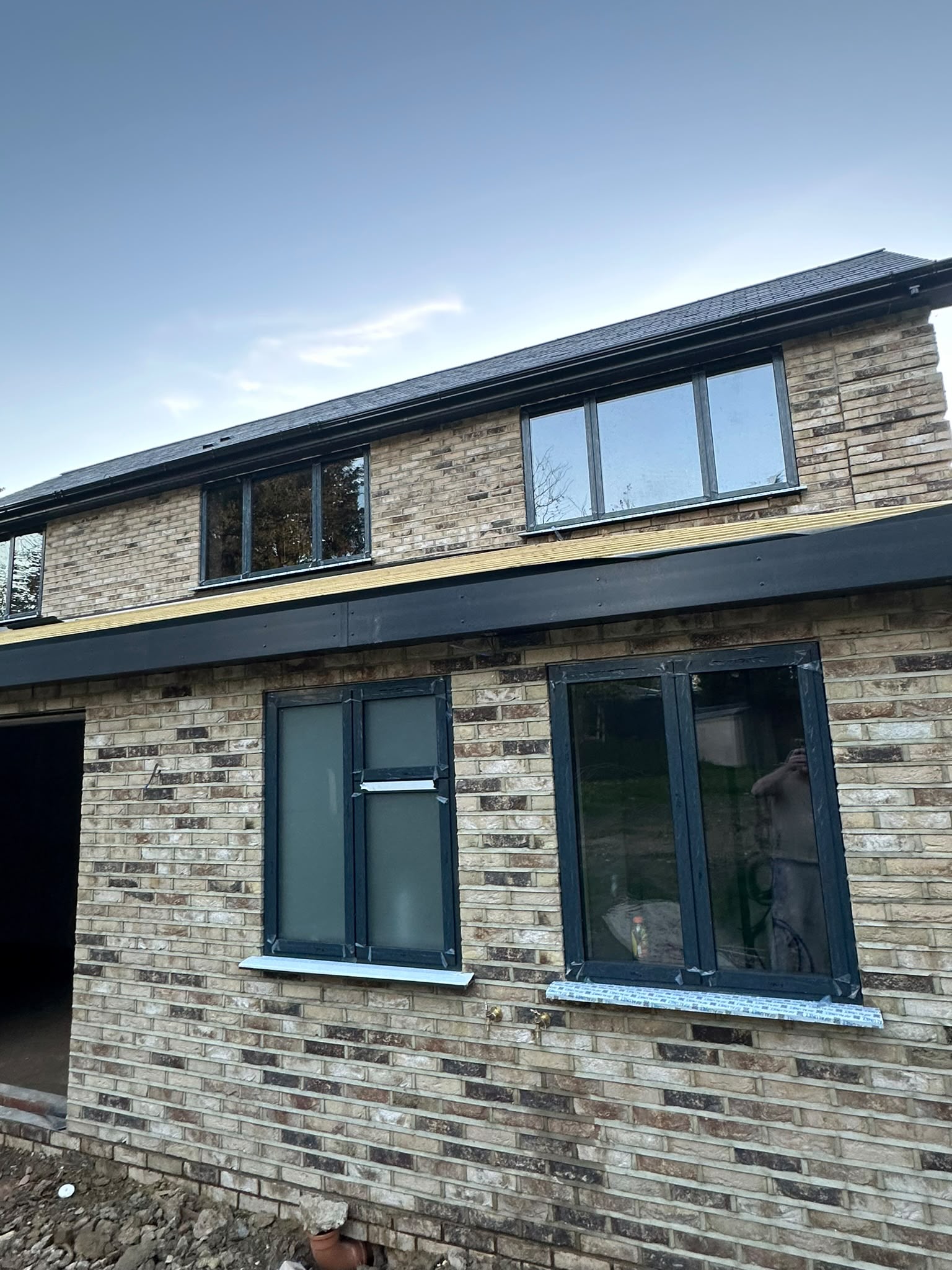 A new exterior taking shape, with brickwork and dark window frames.
