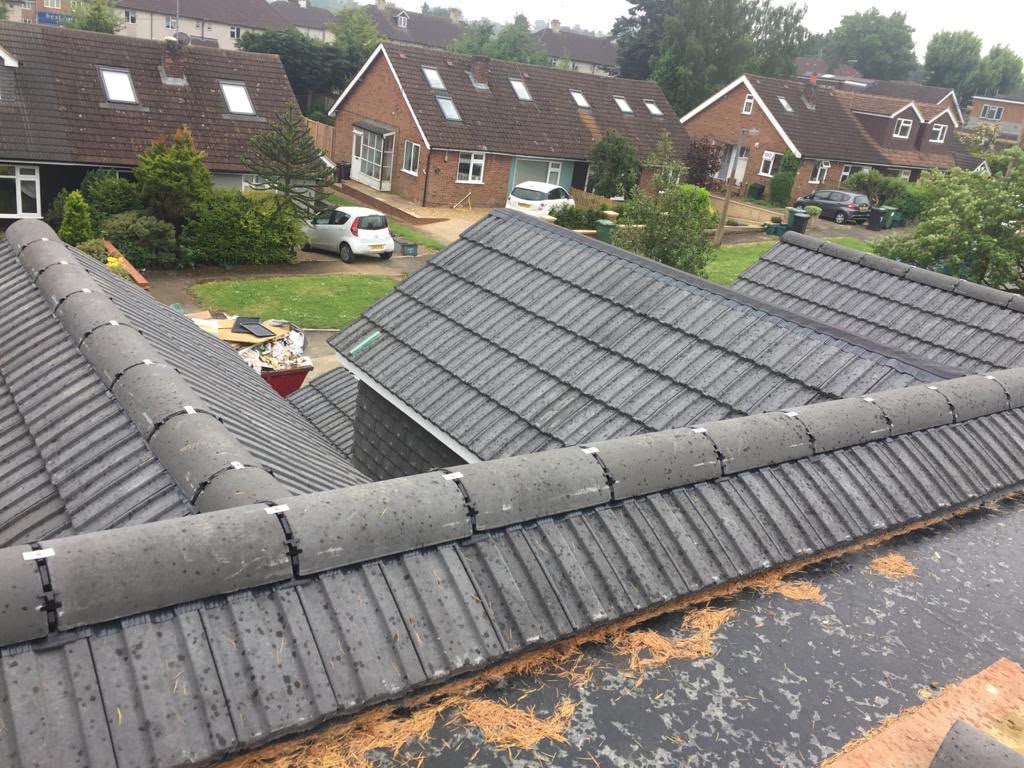 Tiled roof slopes, ridges and dormer detailing.
