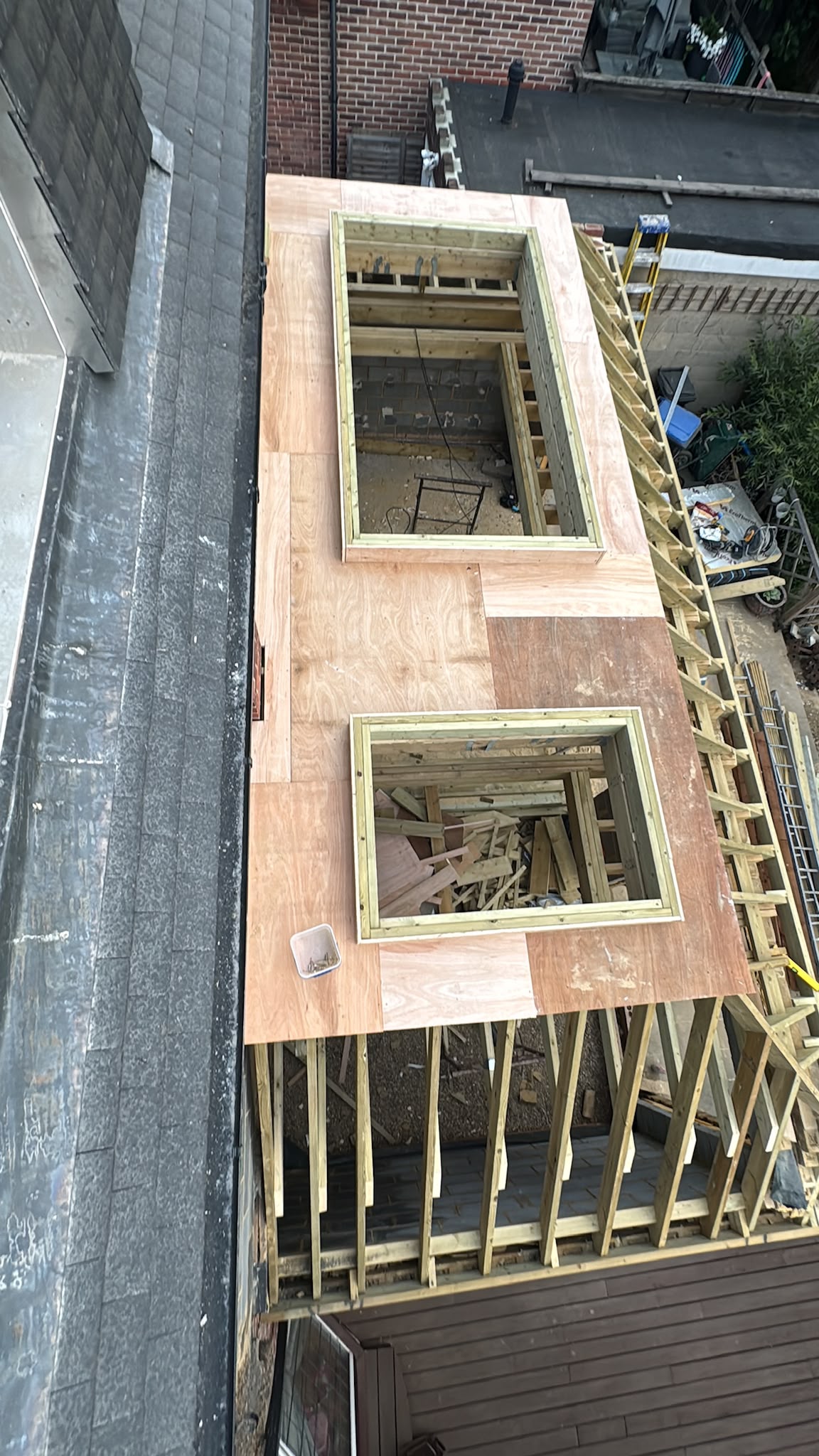 Two rooflight openings set into a new timber roof deck.