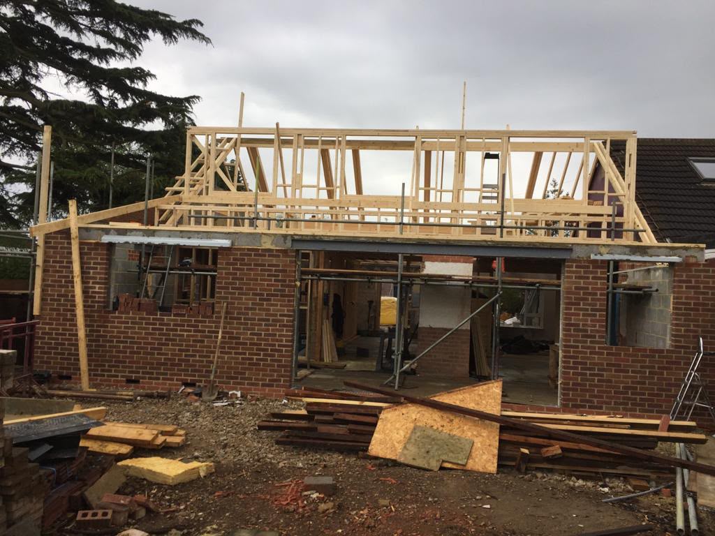 New timber framing above a brick-built extension.