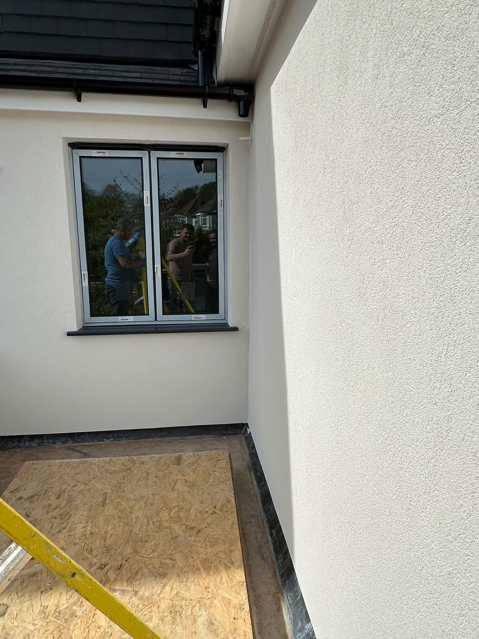 Rendered walls and window detailing during refurbishment.