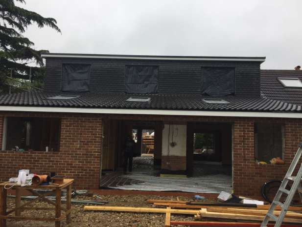 The rear dormer and ground-floor openings during construction.